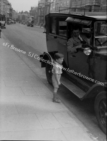 'CURIOSITY' SMALL BOY AT CAR